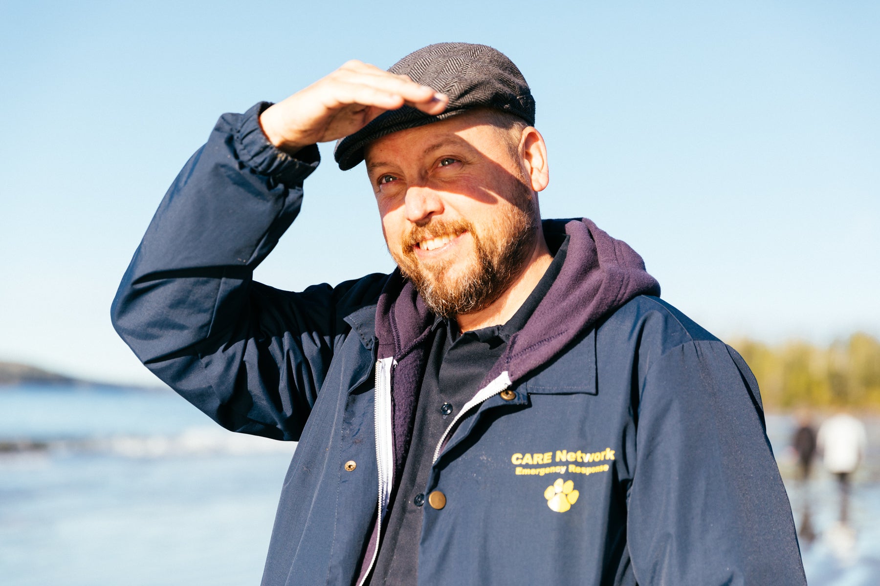 Portrait of James Rodgers in a blue CARE network jacket. 