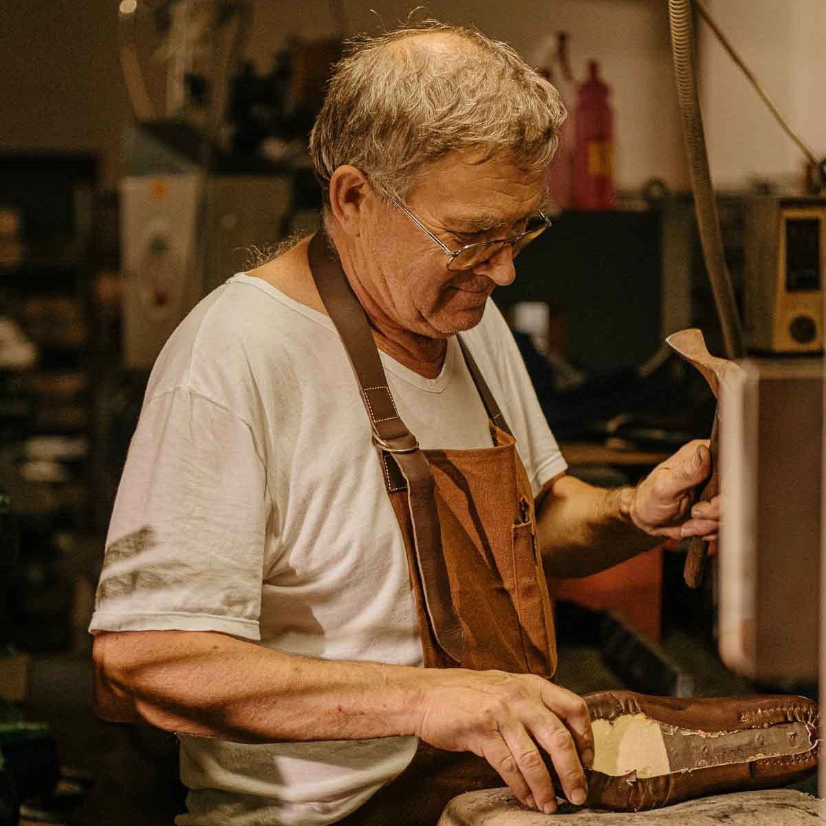 A shoemaker at his workbench. 