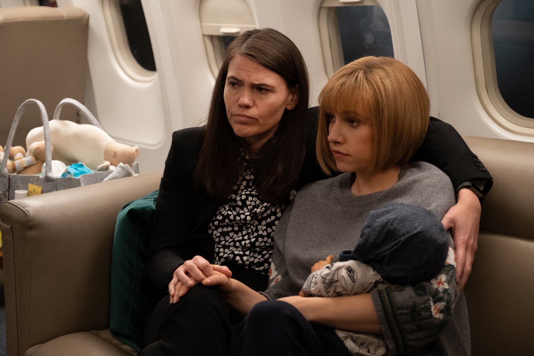 Marjorie and Catherine Meyer cradle their son/Selina’s grandson on the campaign plane.