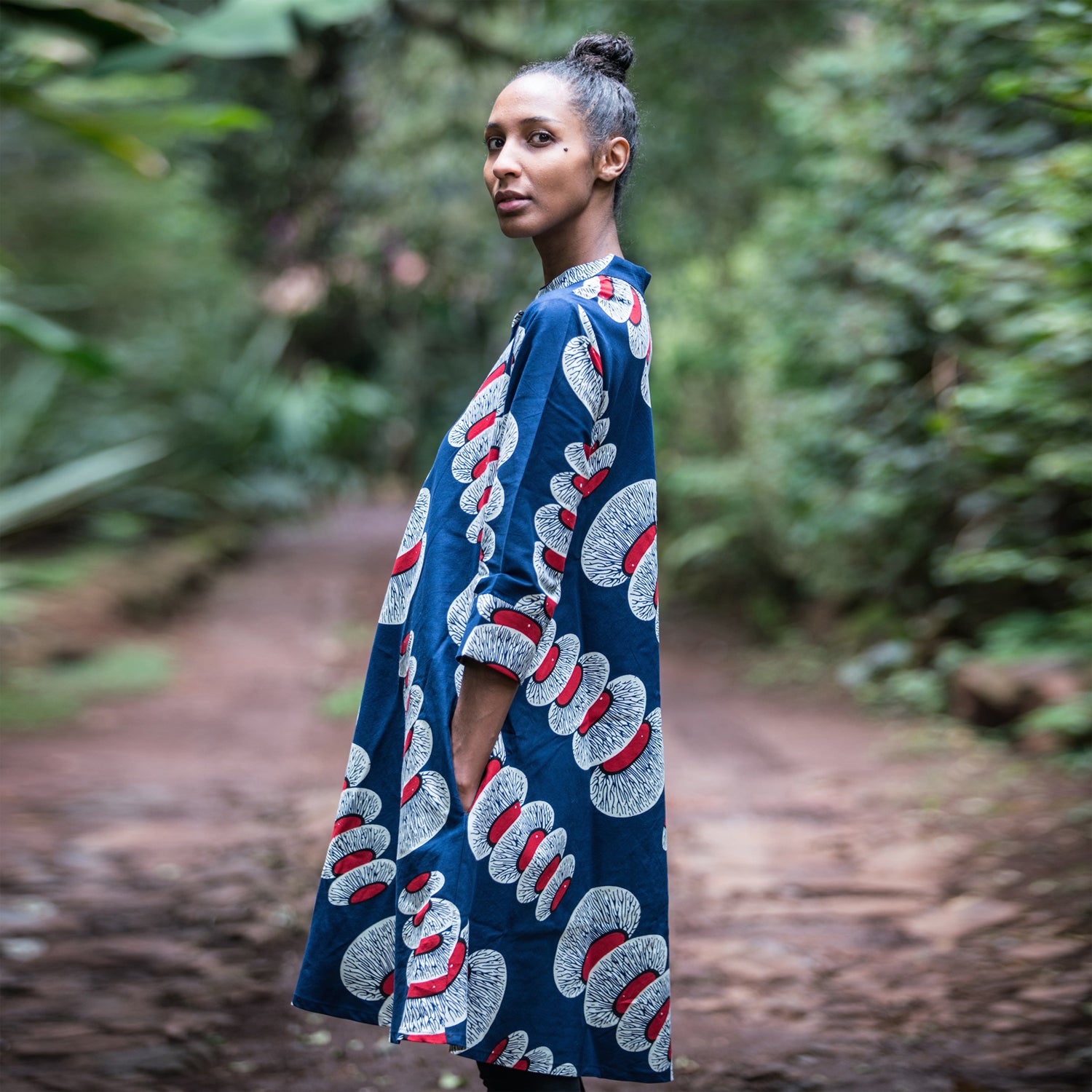Kenyan social-media maven Diana Opoti stands outside wearing a colourful Zuri dress.