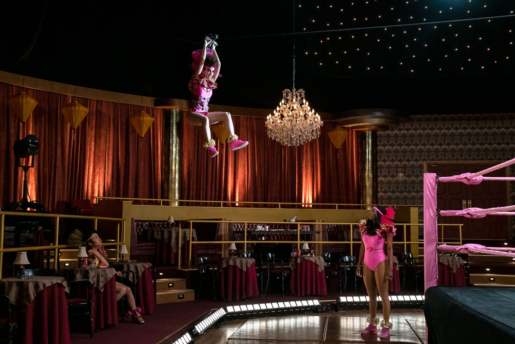 Zoya the Destroya zip lines into the ring wearing a pink and gold costume during rehearsals for GLOW. 