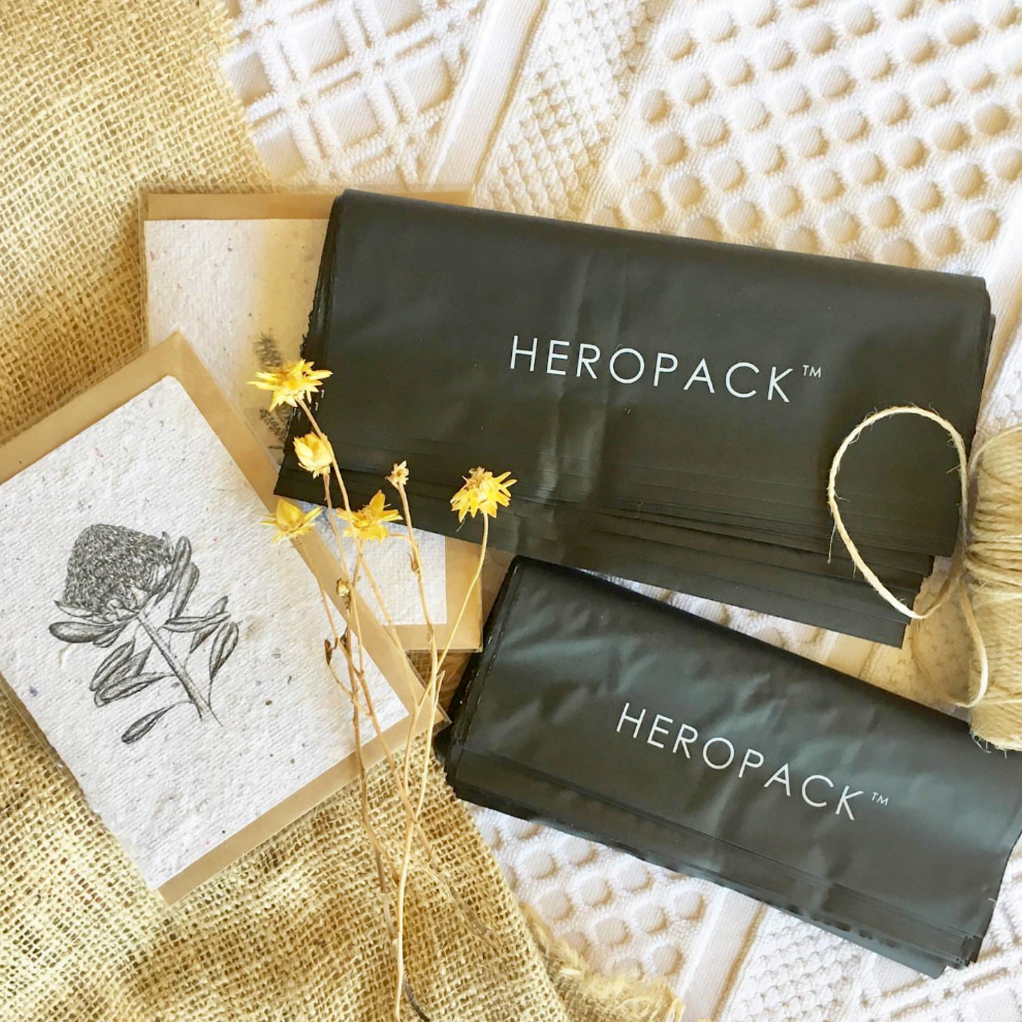 Black compostable mailers made by Hero Packaging. 