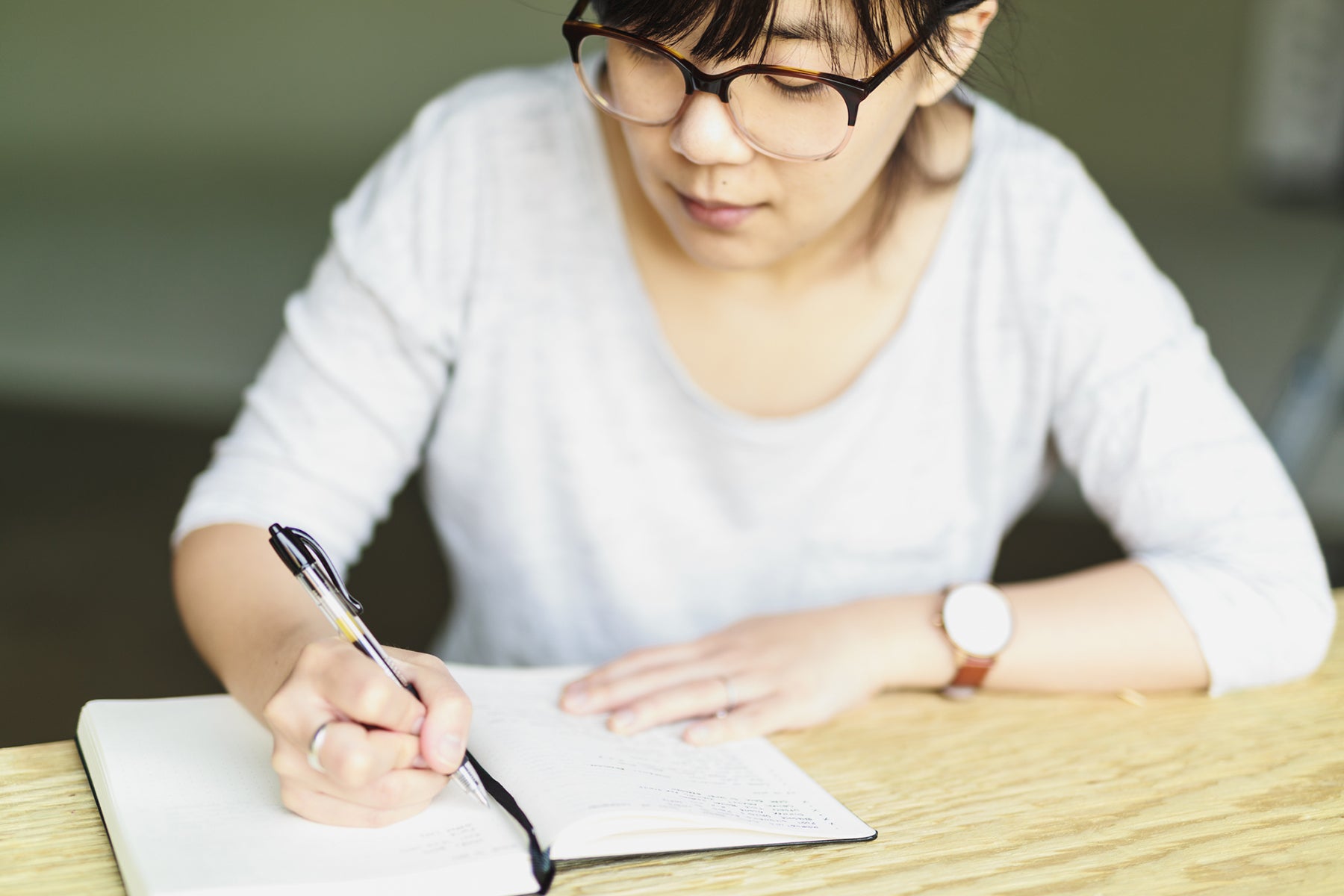 A Bullet Journal user journals in her notebook. 