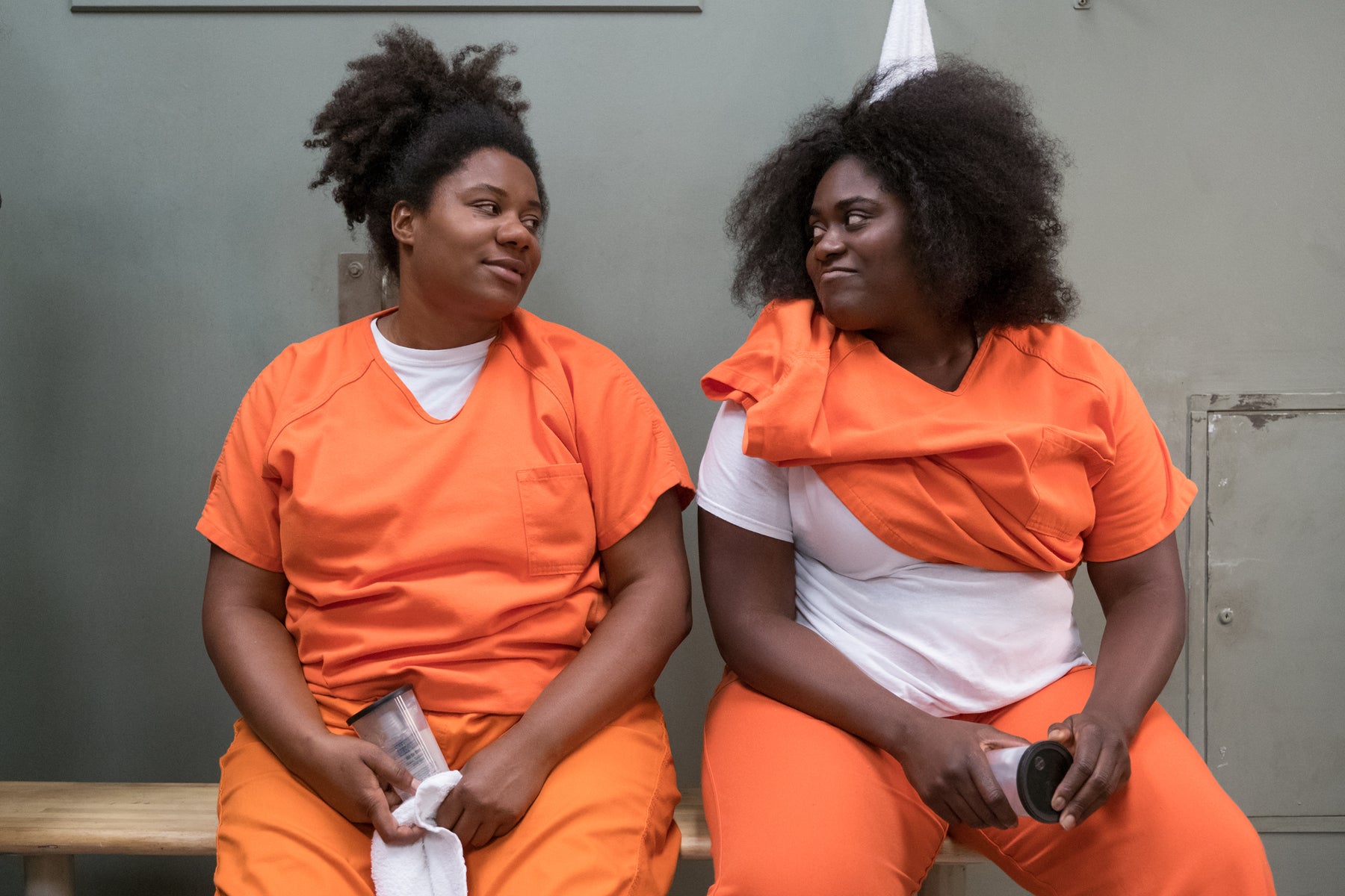 Taystee Jefferson and Cindy Hayes sit in a jail cell looking at each other in an episode of Orange Is the New Black.