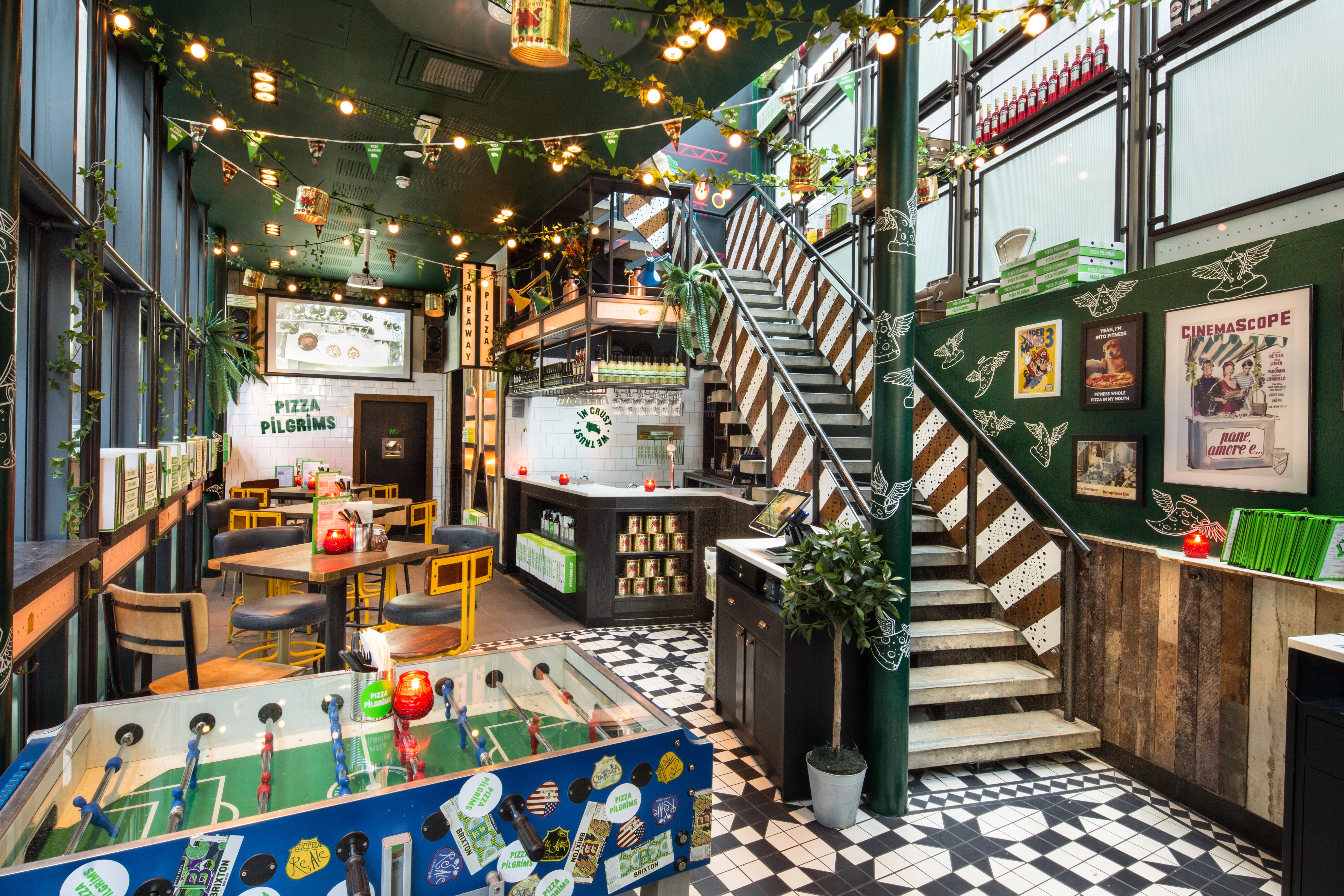 The interior of Pizza Pilgrims’ City location, complete with foosball tables and seasonal specials. 