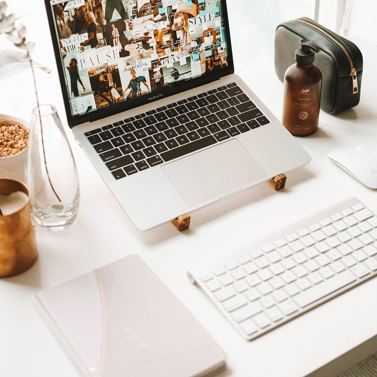 A blush coloured STIL planner next to a workstation setup. 