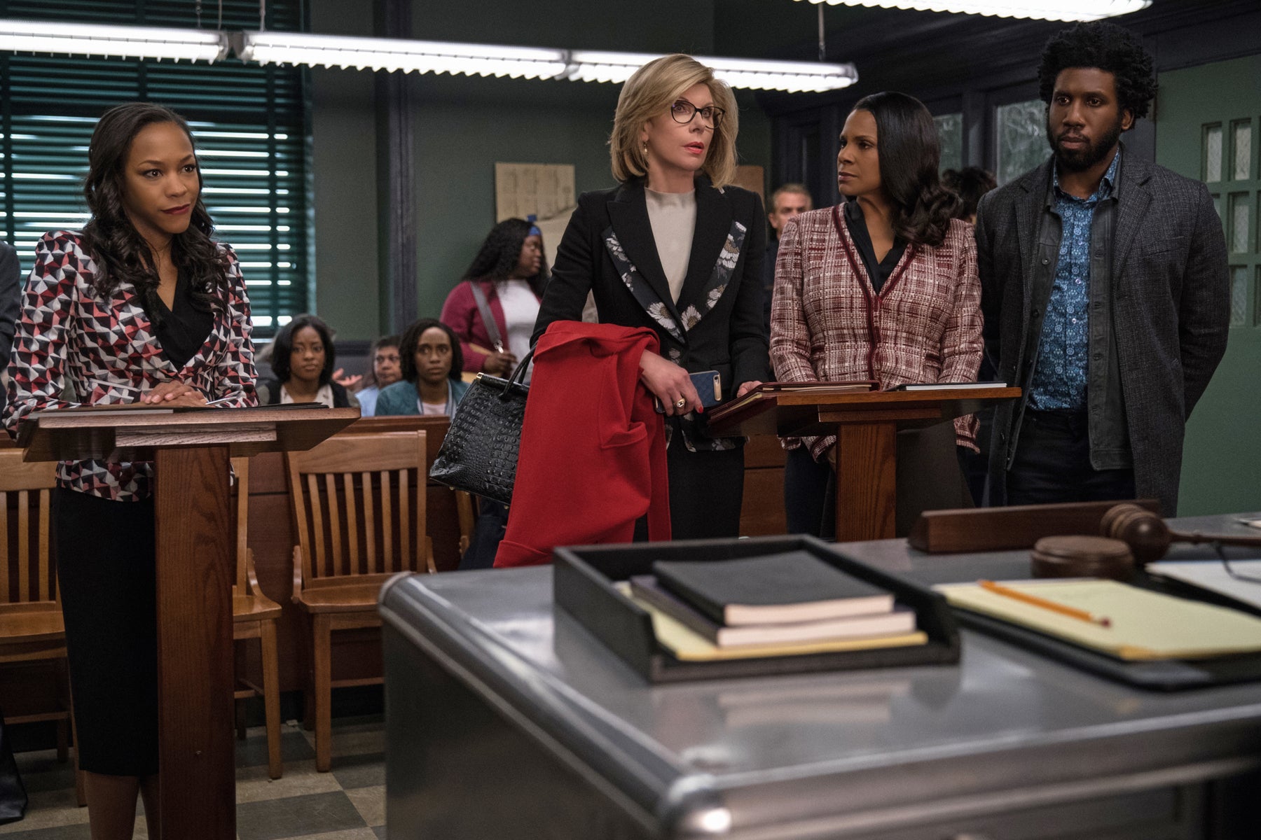 Jay Dipersia is defended by Diane and Liz during a court hearing where the US government is trying to deport Jay.