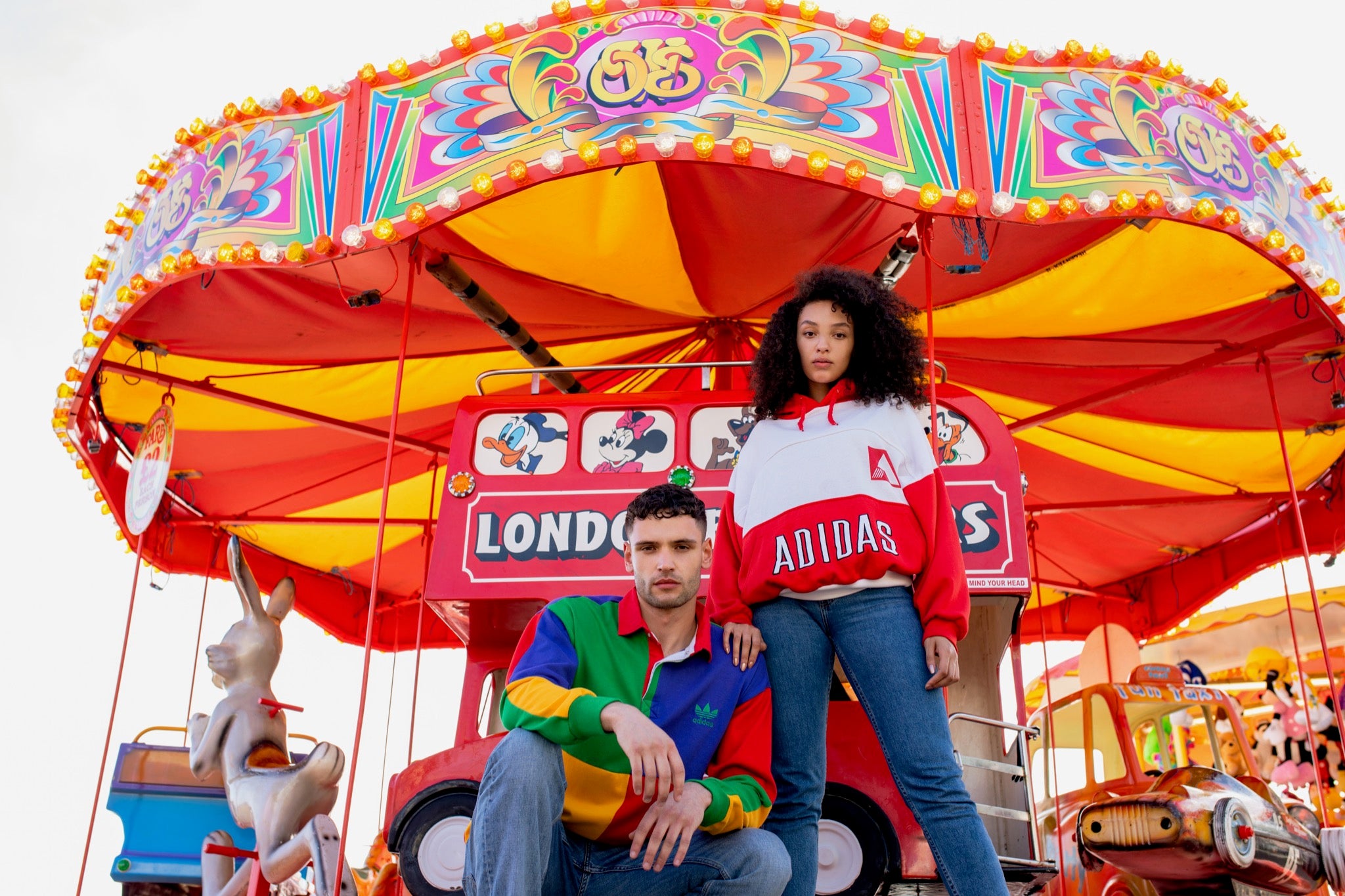 Two models wearing True Vintage clothing in a carnival setting. 