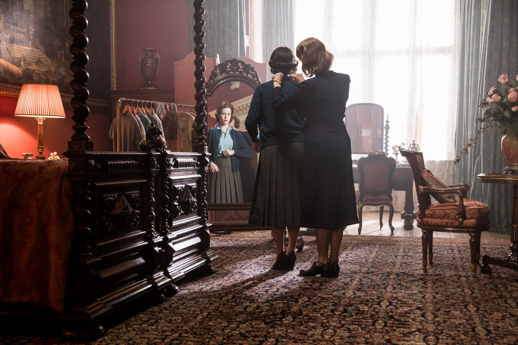 Queen Elizabeth gets sized for clothes in front of the mirror