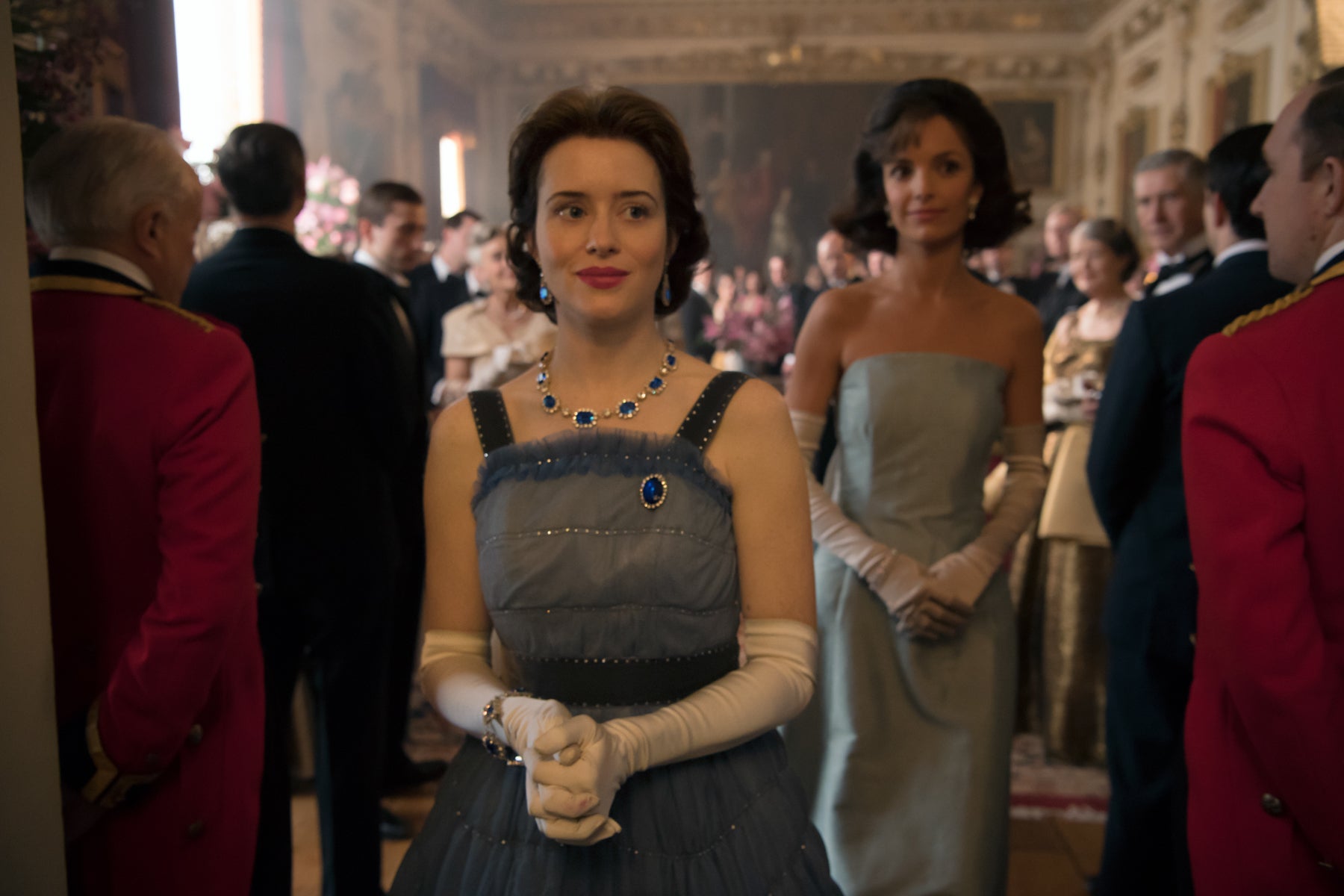 Queen Elizabeth (Claire Foy) takes Jackie Kennedy (Jodi Balfour) on a tour of Buckingham Palace