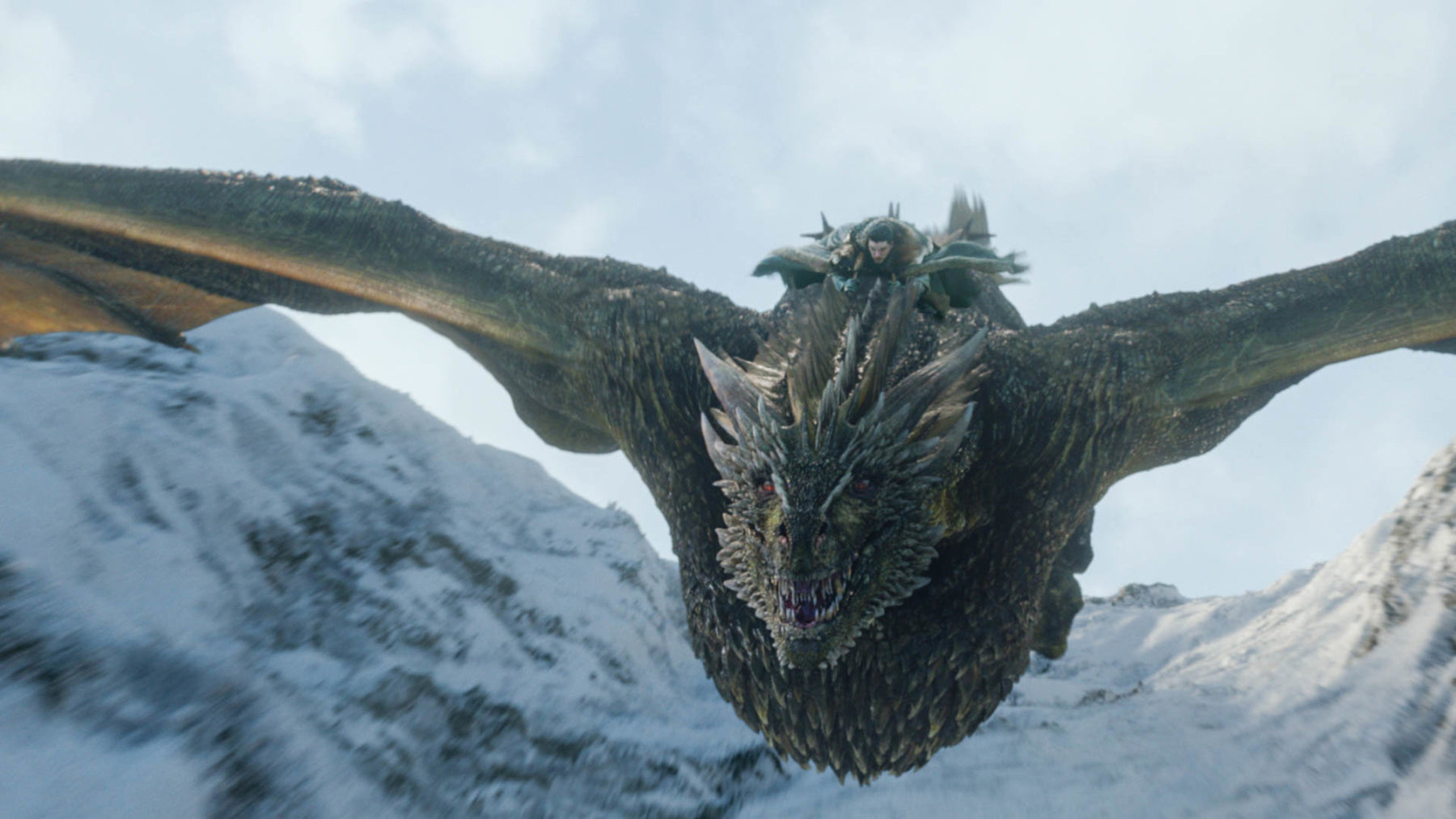 Jon Snow rides on the back of one of Daenerys’s dragons through the mountains in the North.