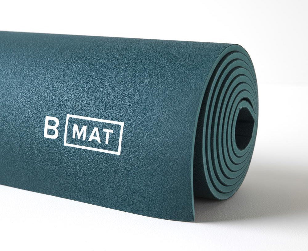 Closeup of a B Mat rolled yoga mat in blue
