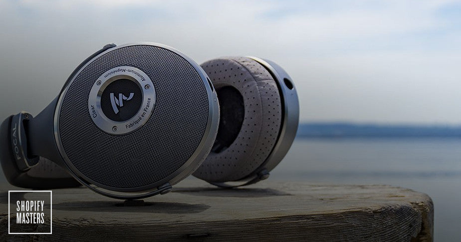 A pair of headphones resting on a wooden surface. 