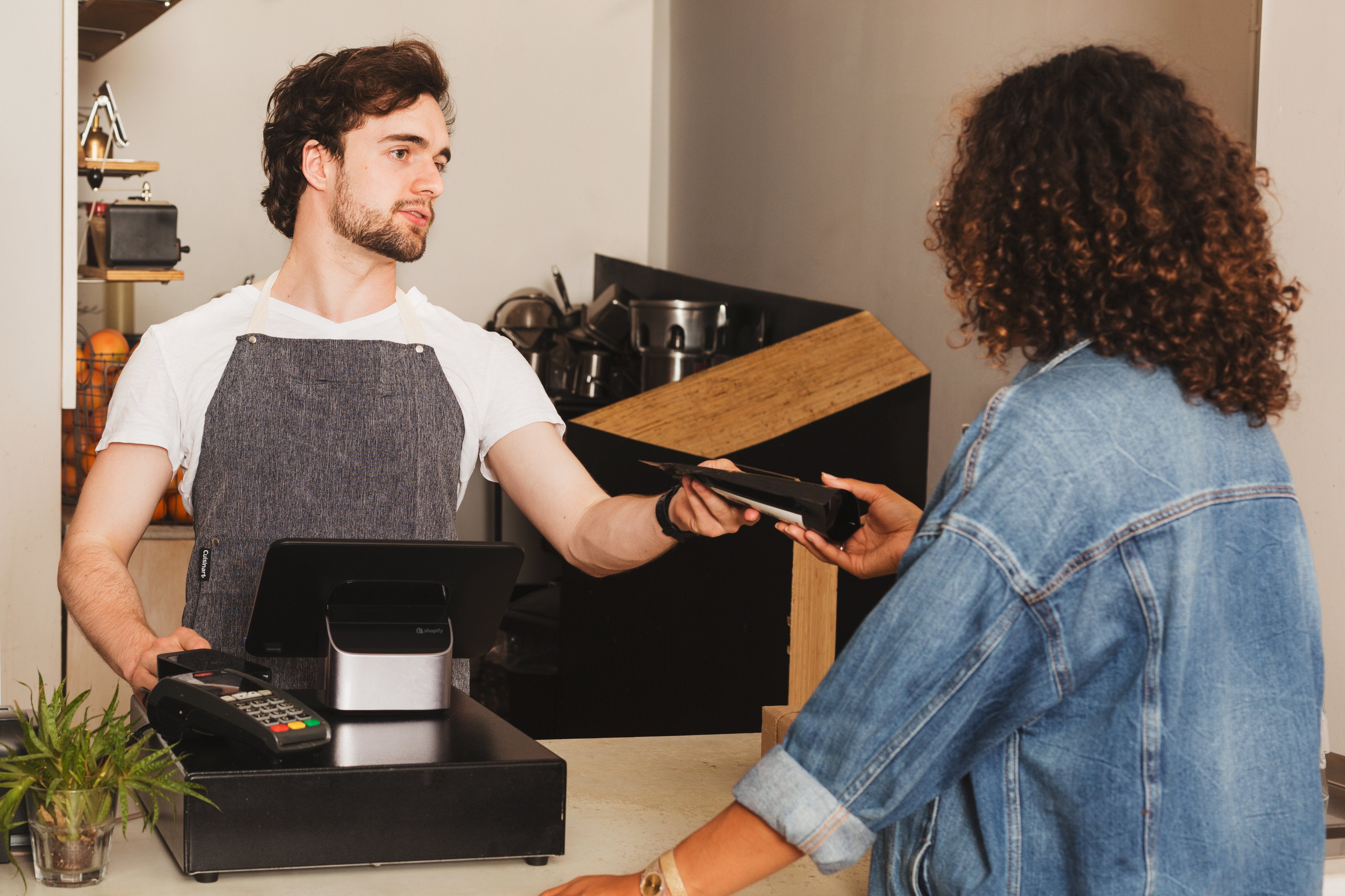 Cashier and customer interacting through a purchase. 