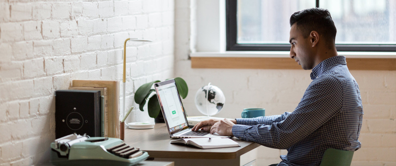 Man on laptop at his desk