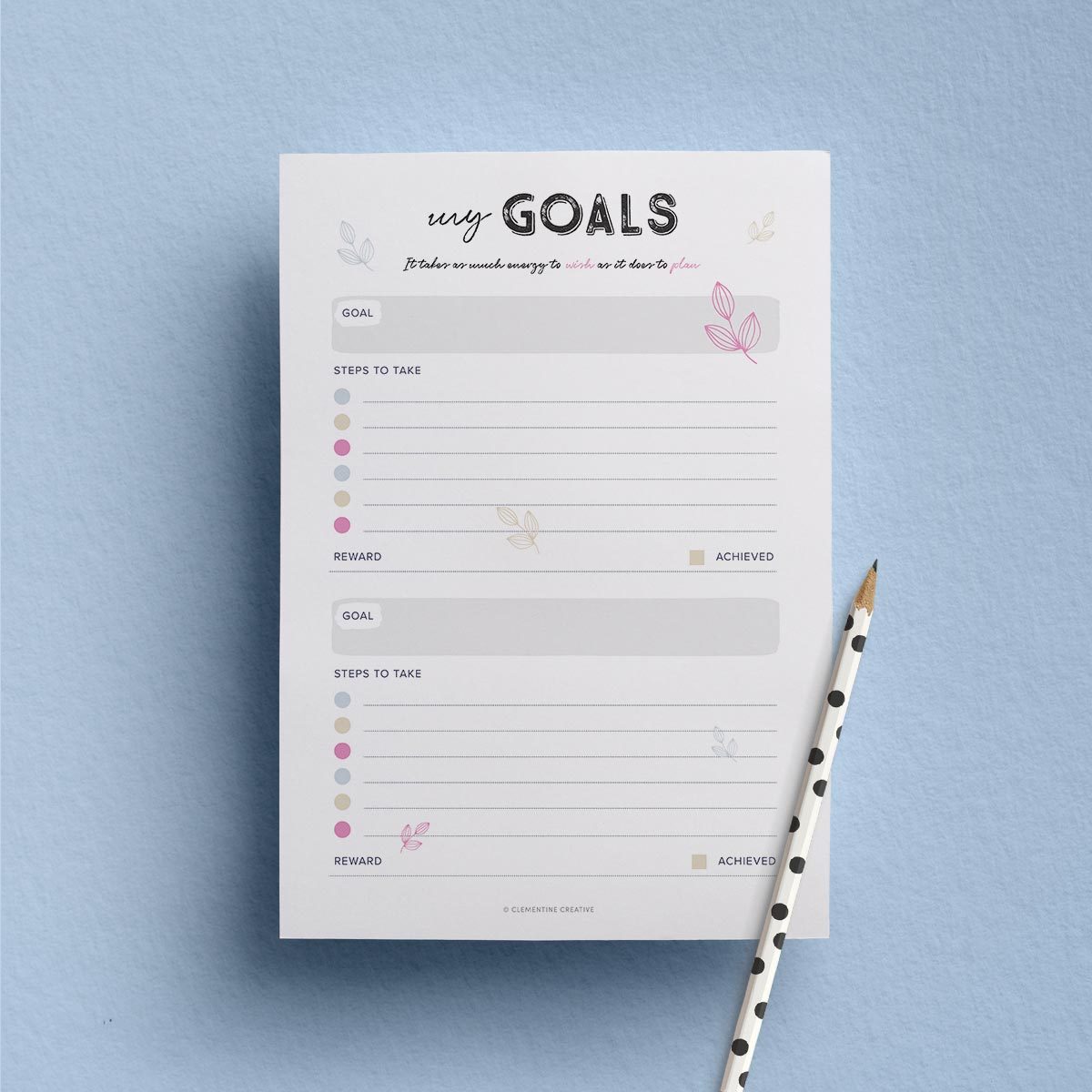 Clementine Creative goals template on a blue surface with a pencil