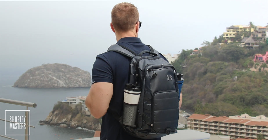 man wearing backpack with ice shaker, shopify masters logo in corner