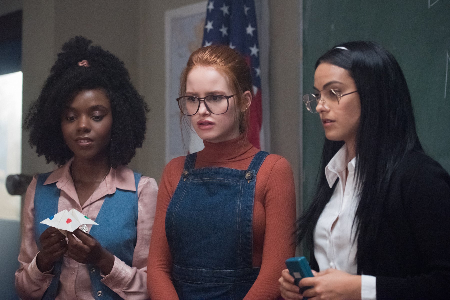 In a flashback scene, young versions of Sierra McCoy, Penelope Blossom, and Hermione Lodge stand in a line.