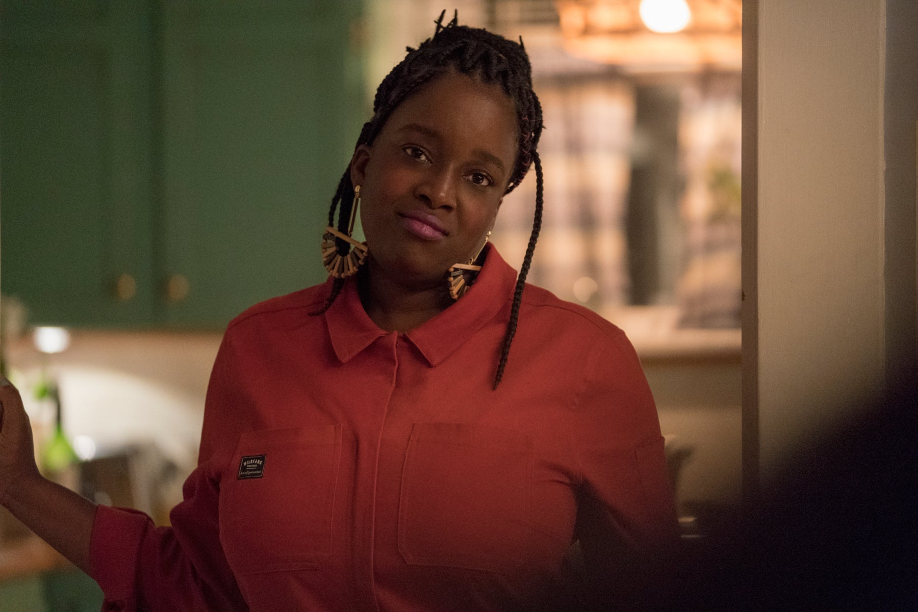 Annie’s roommate, Fran (Ololade “Lolly” Adefope), looks judgmental while standing in a doorway. In this scene from Shrill, she is listening to Annie talk about work.  
