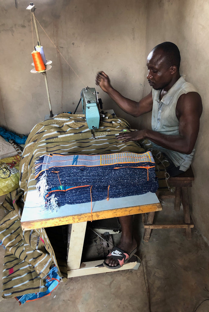 man sewing the woven fabrics together