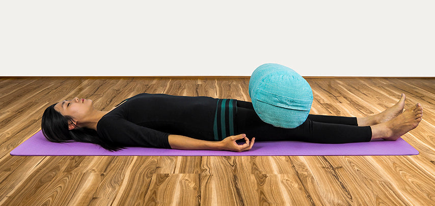 Explore GROUNDING in Savasana  Use the comfortable weight of a bolster to anchor the biggest bones in the body - the femurs.