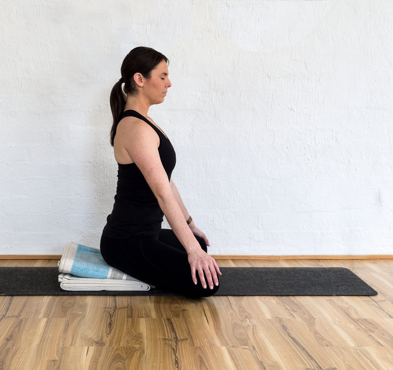 Simple cross-legged pose (sukhasana) using yoga blanket