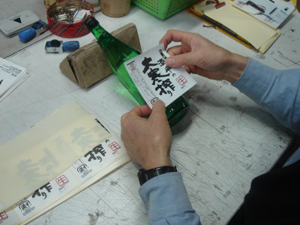 The finishing touches on the bottles of sake!
