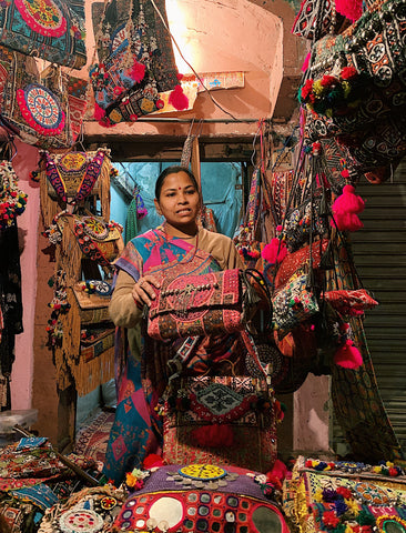a women selling vibrant handbags in delhi india