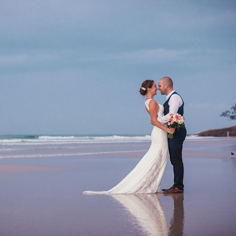 Wedding Photography on North Stradbroke Island Straddie by Julie Sisco. A newly married couple embrace at the beach for the bridal portraits