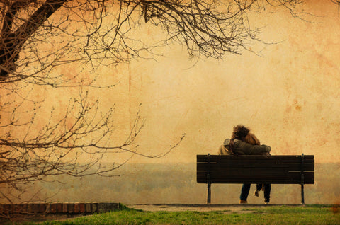romantic couple sitting on a bench