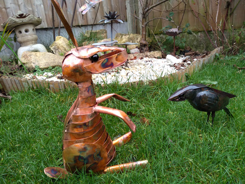 Copper hare and carrion crow sculpture