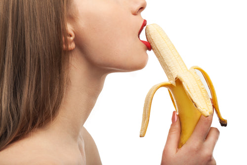 Image of woman with mouth around banana