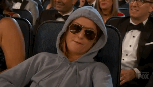 Gif of A Woman In A 
Hoodie And Sunglasses