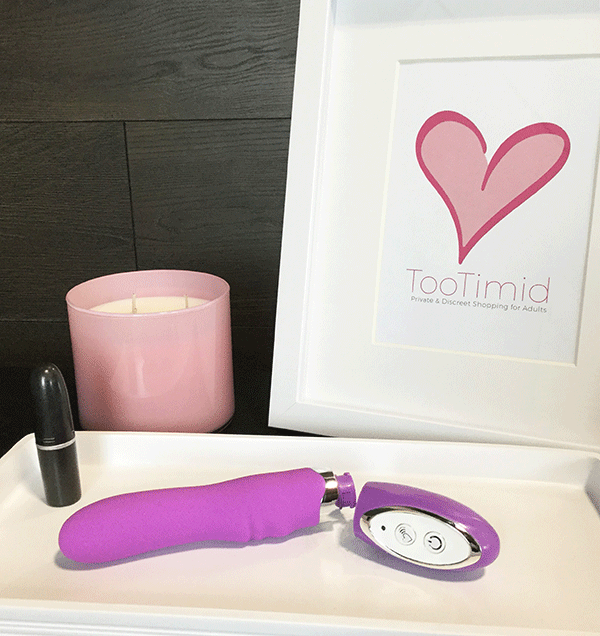 Pink B.O.B. Beginner's Silicone 10 Function Vibrator on a nightstand