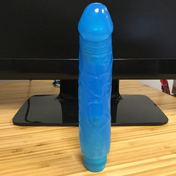 Blue Realistic Vibrator Shown Standing Next To Computer Screen To Show Size