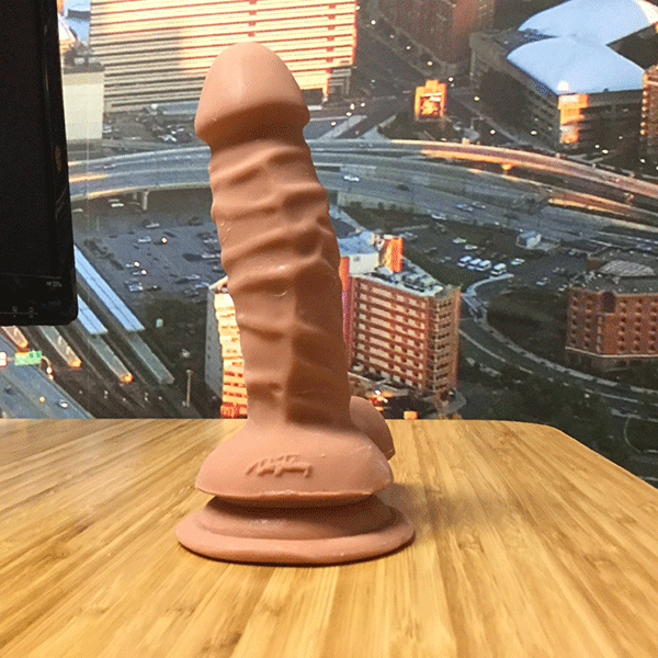 Realistic Dildo Shown Standing Up Using Suction Cup Base