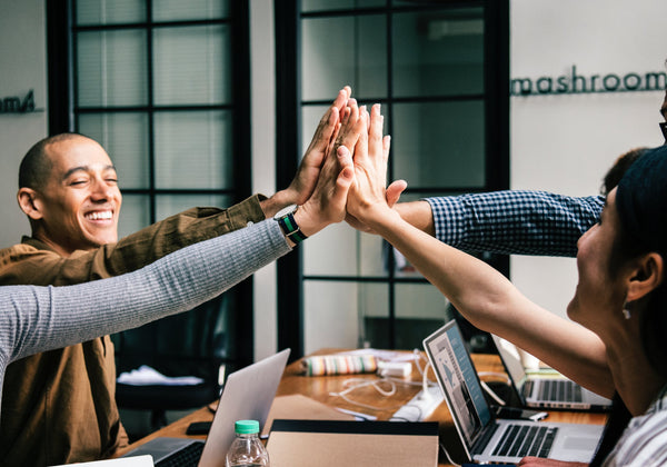 4 happy people giving high five productive smiling people 