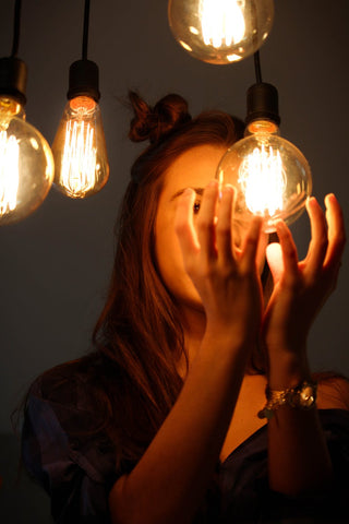 Women touching light bulbs 