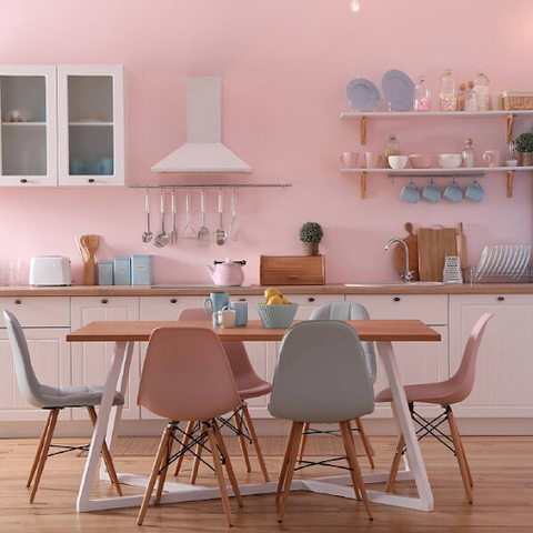 Pink kitchen design with copper lighting