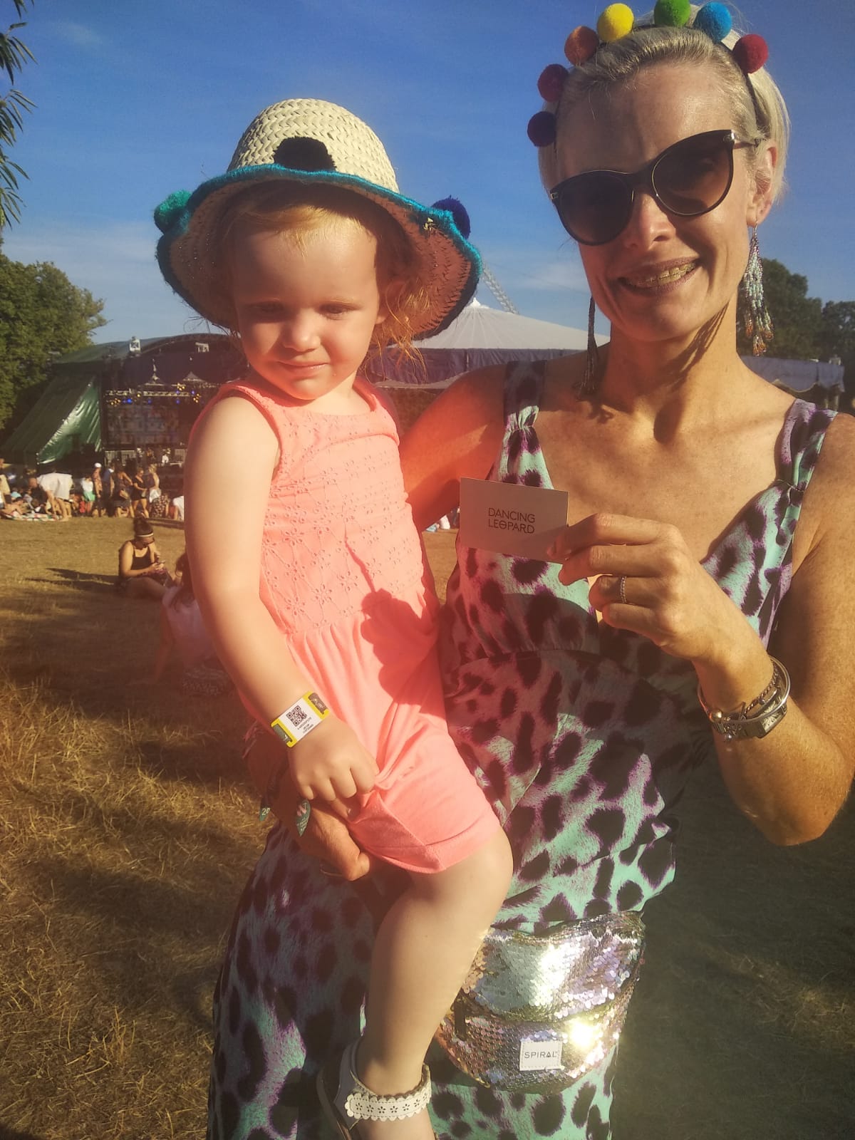 lady holding young child wearing Dancing Leopard dress at Wilderness Festival