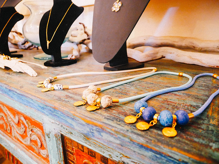 necklaces placed on a wooden surface