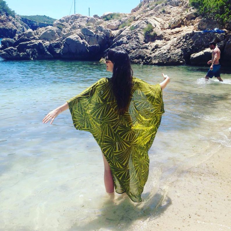 Sarah Seaton in sea at Cala Salada beach wearing Dancing Leopard kimono
