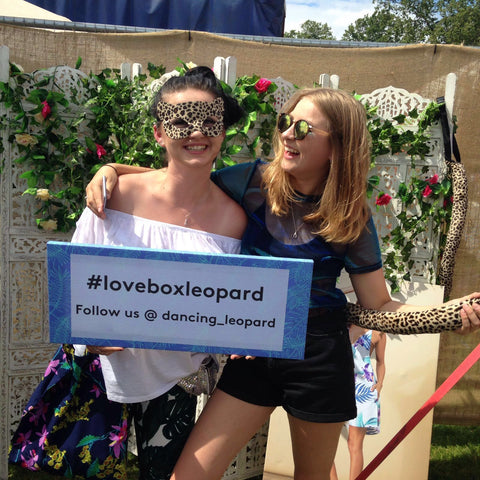 two girls holding #loveboxleopard sign at Lovebox