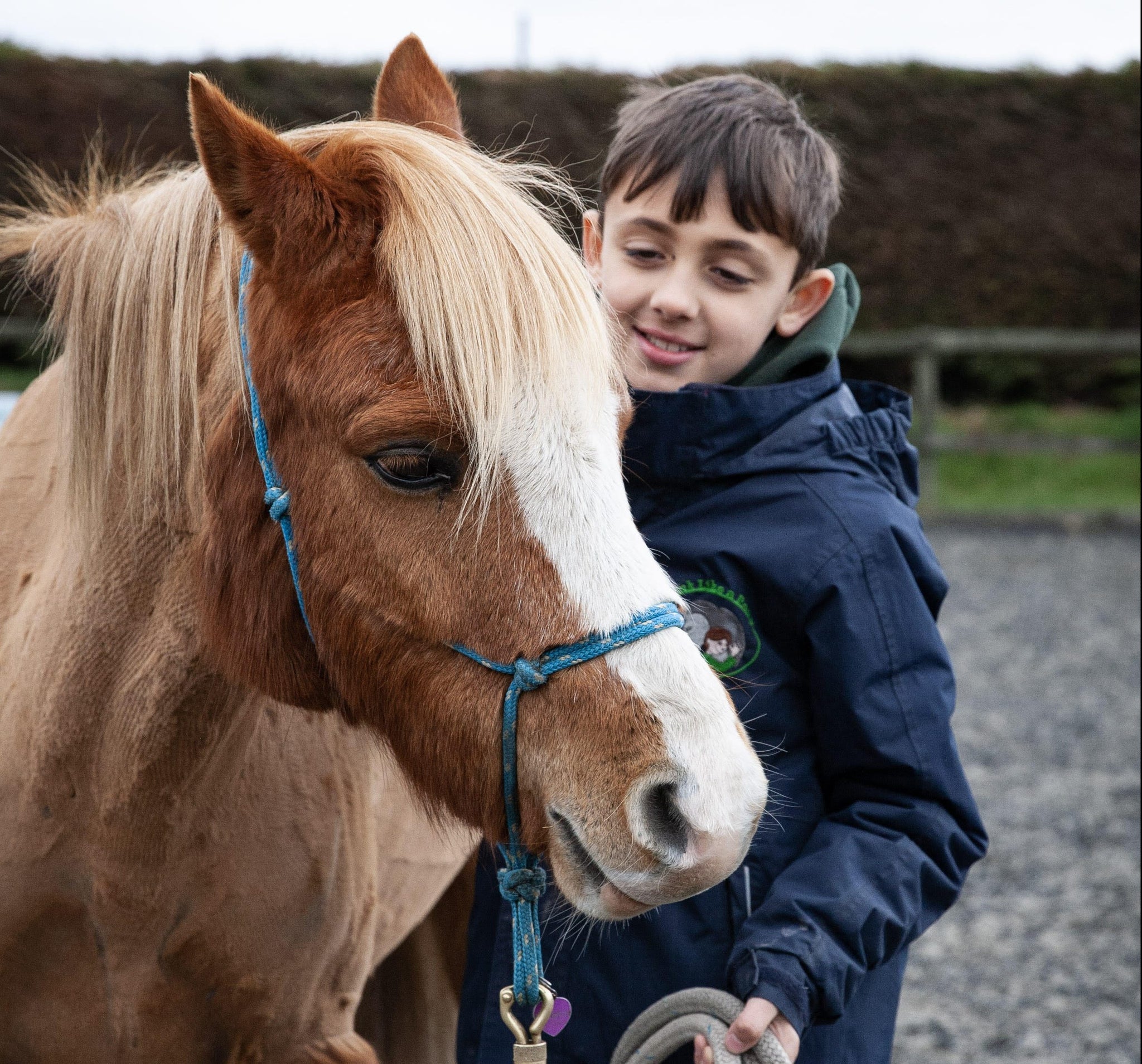 young boy leading a pony