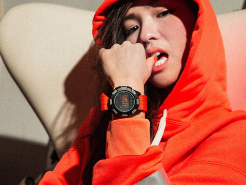 Orange Black AAASY watch on wrist with Orange Hooded sweatshirt