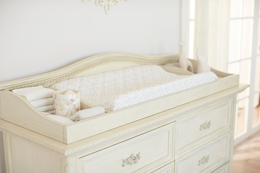 Elegant white dresser with matching changing table, perfect for your baby's nursery. Shop now!