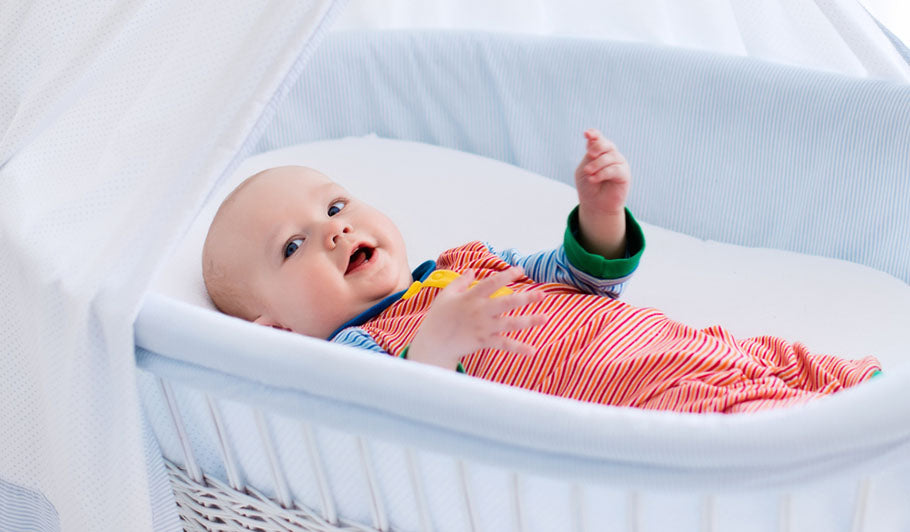 happy baby in bassinet