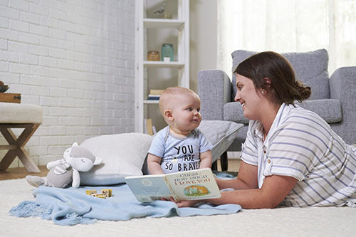 mom reading book to baby