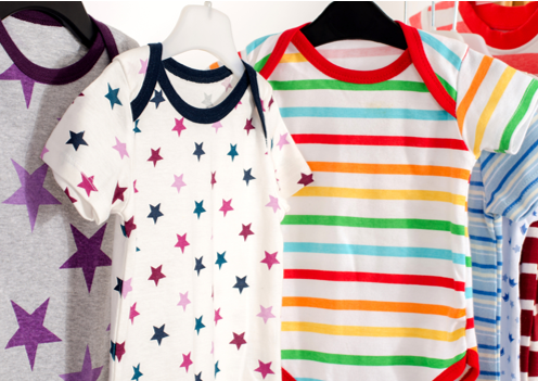 Gerber onesies bodysuits with colorful patterns on hangers
