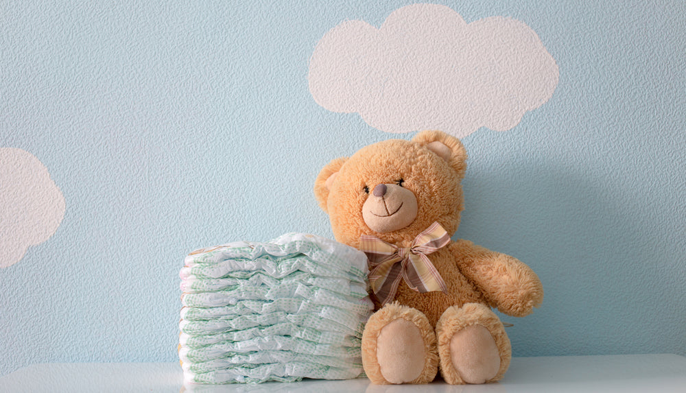 plush bear beside diapers